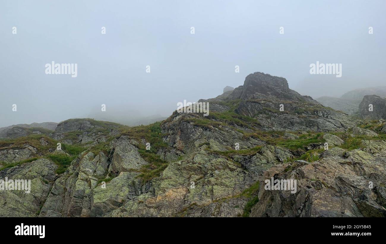 View of rocky hills on a foggy day Stock Photo - Alamy