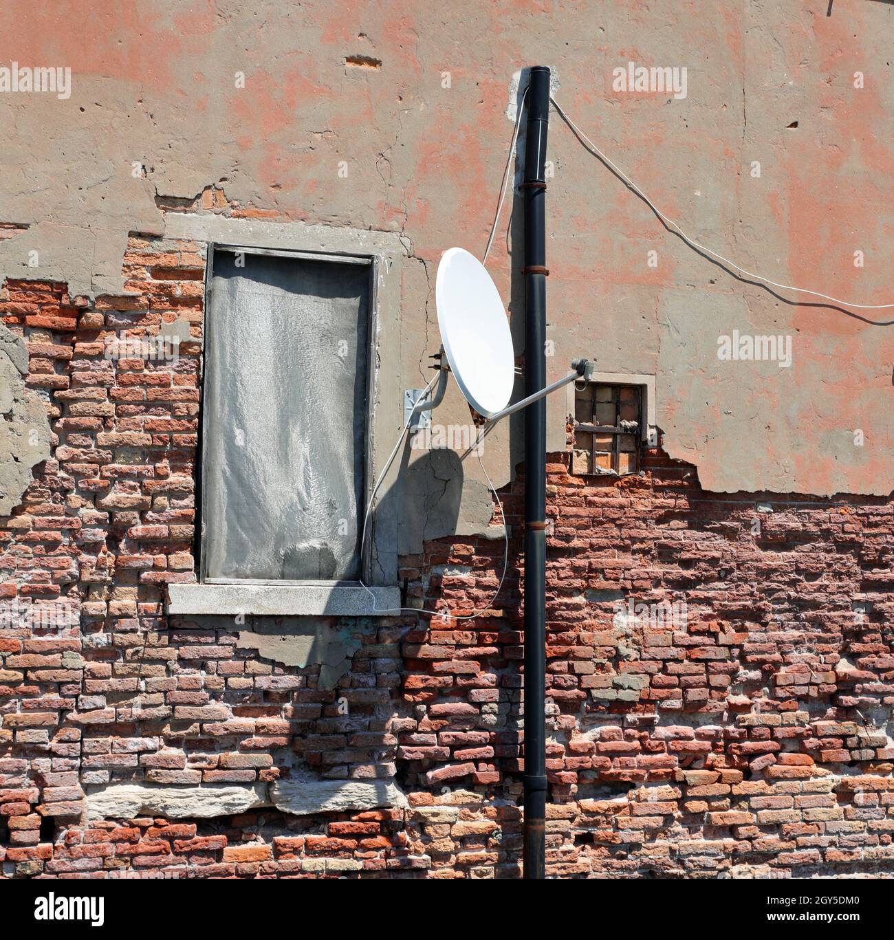 satellite dish for receiving TV satellite channels in a decrepit 