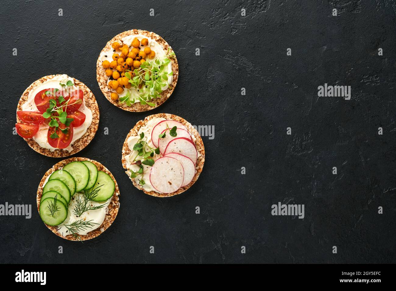 Four crispy buckwheat bread with cream cheese, radish, tomato, chickpea