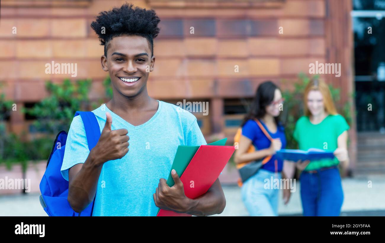 group of students with diploma showing thumbs up Stock Photo - Alamy