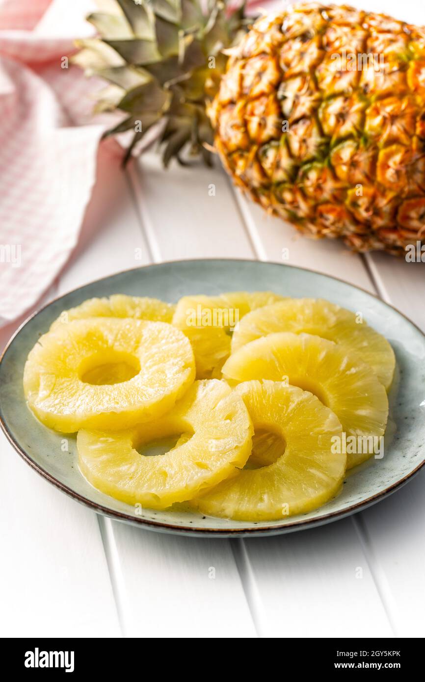 Canned sliced pineapple fruit on plate. Stock Photo