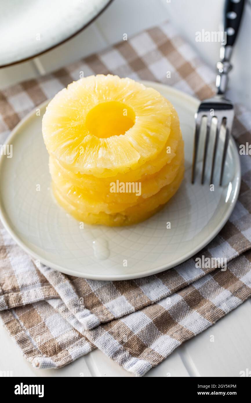 Canned sliced pineapple fruit on plate. Stock Photo