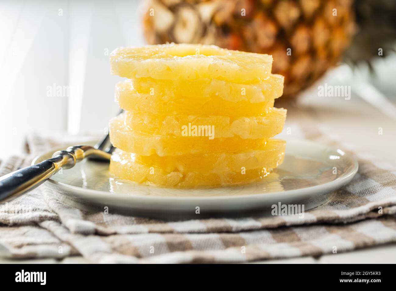 Canned sliced pineapple fruit on plate. Stock Photo