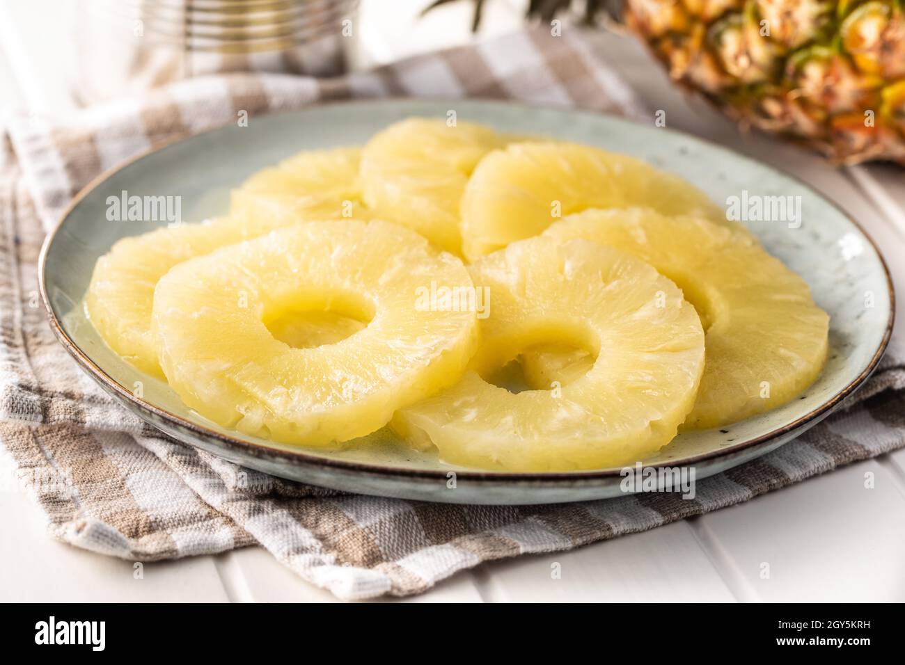 Canned sliced pineapple fruit on plate. Stock Photo