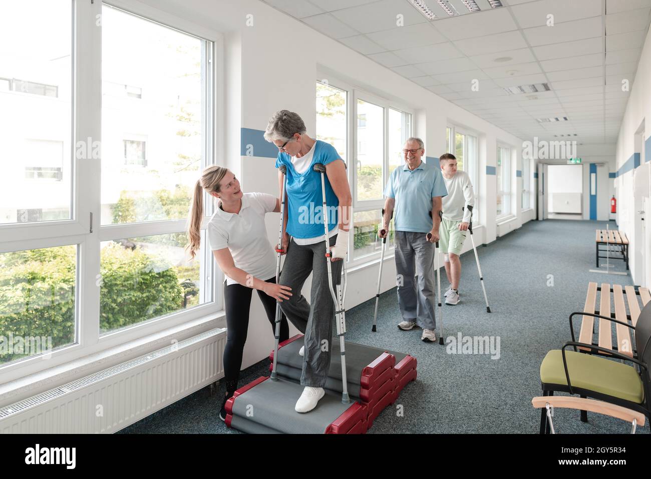 Seniors in rehabilitation learning how to walk with crutches after