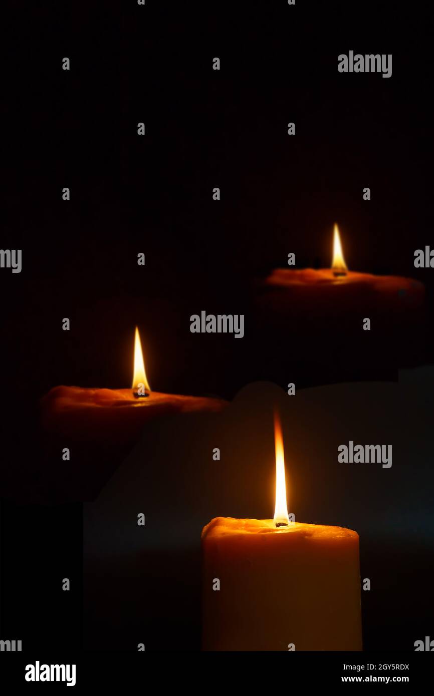 The light of a candle illuminate the darkness Stock Photo Alamy