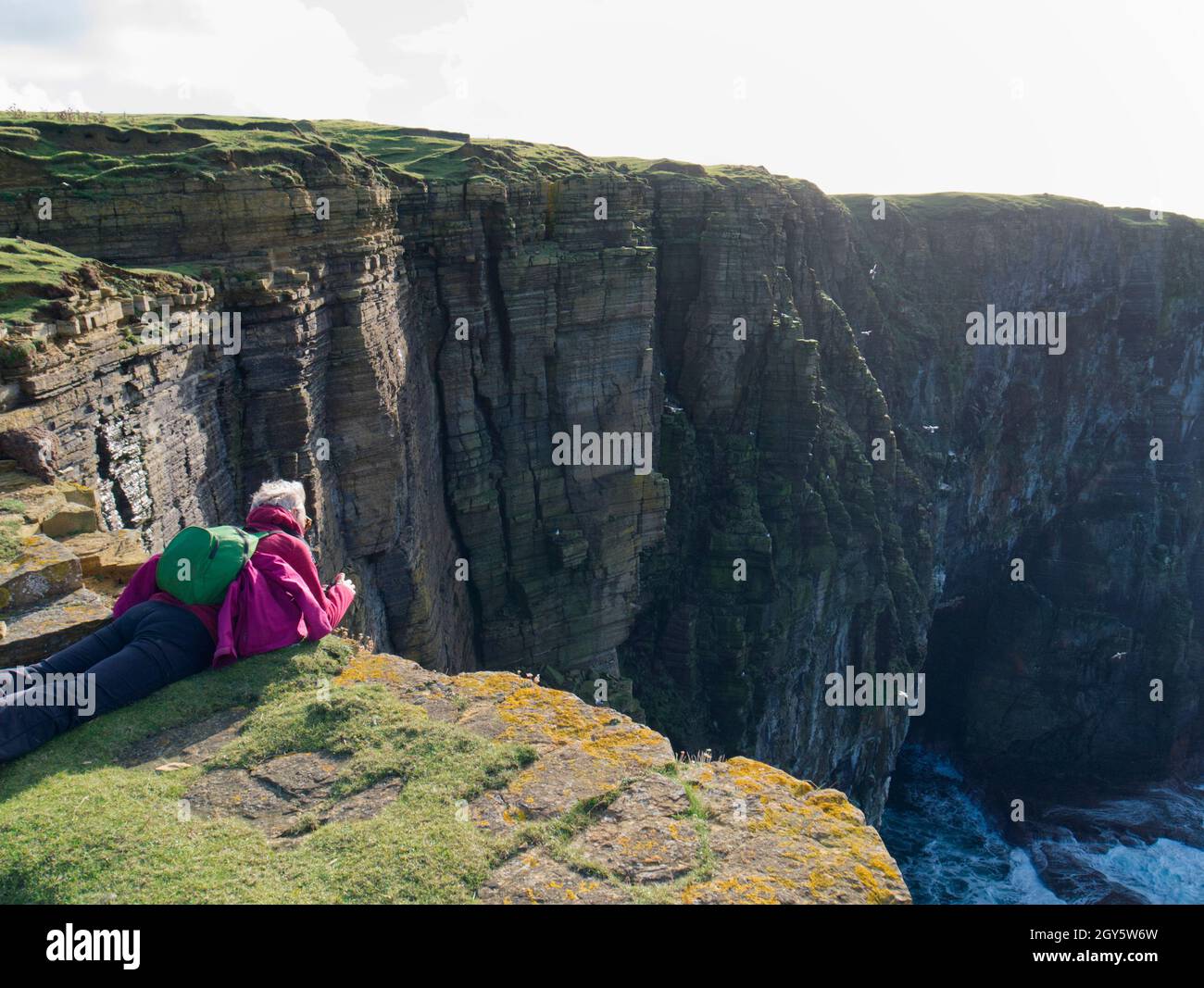 Photographer on Orkney clifftop, Scotland Stock Photo
