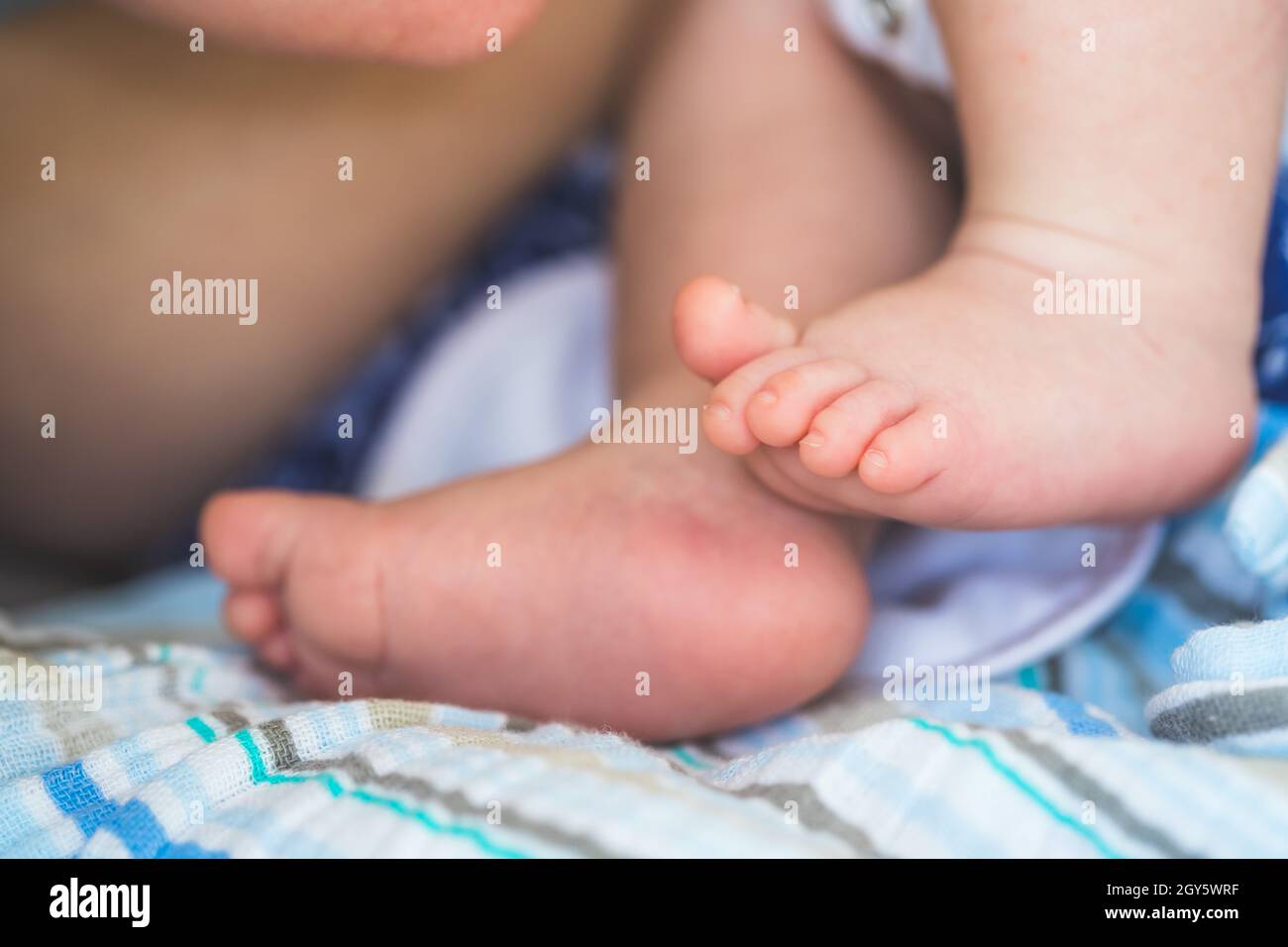 Close up of newborn baby feet on baby blanket Stock Photo Alamy