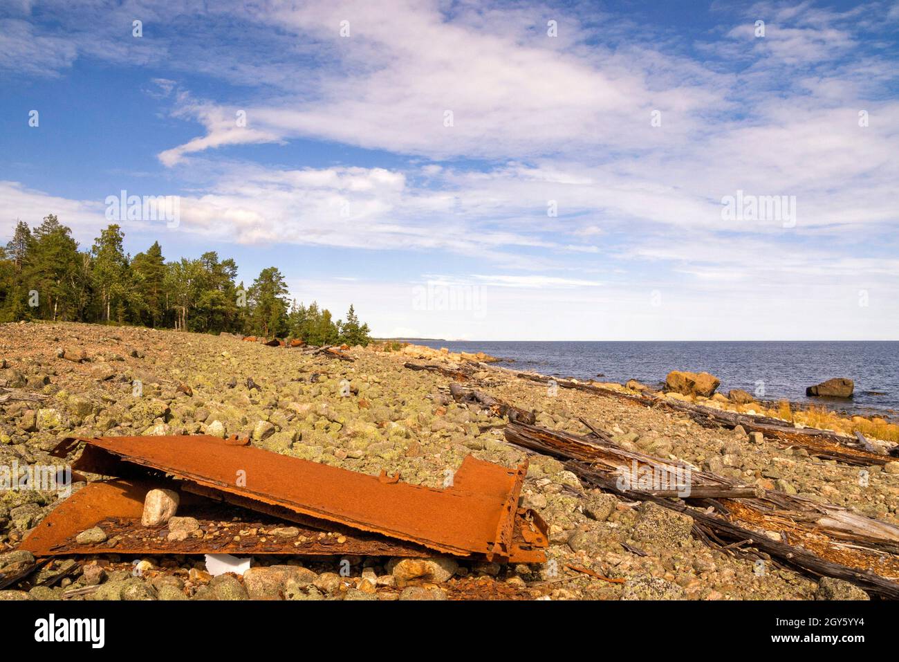 Rusty remains from a ship on a rocky beach along the Bothnian Sea on the Hornslandet peninsula close to the Swedish city Hudiksvall Stock Photo