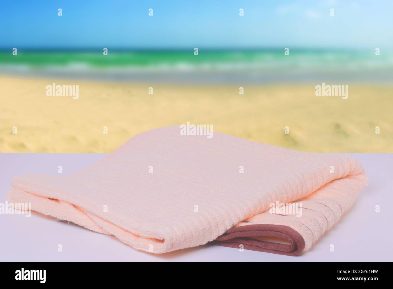 Summer beach travel concept. Closeup of a bright folded bath towel on a ...