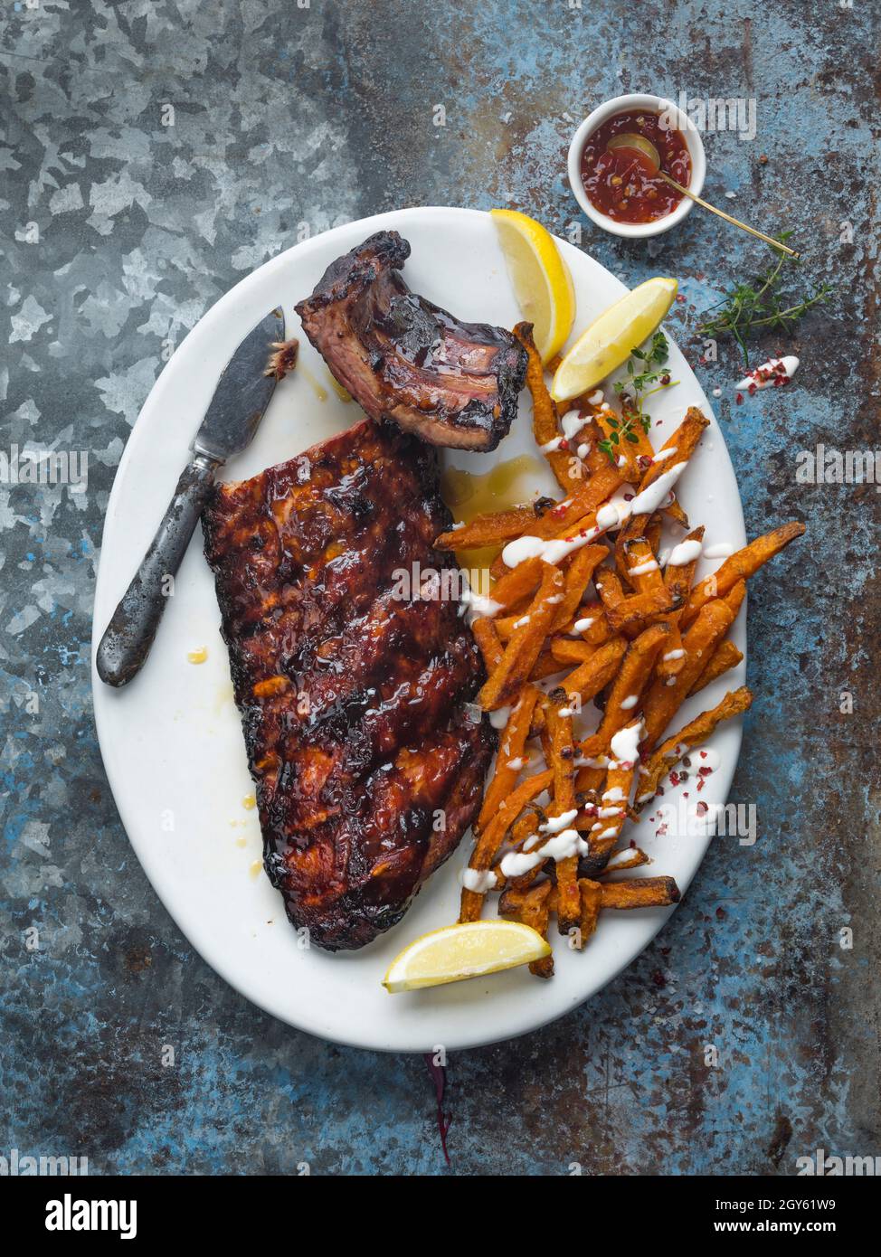 Pork Ribs and sweet potato chips with chilli jam Stock Photo Alamy