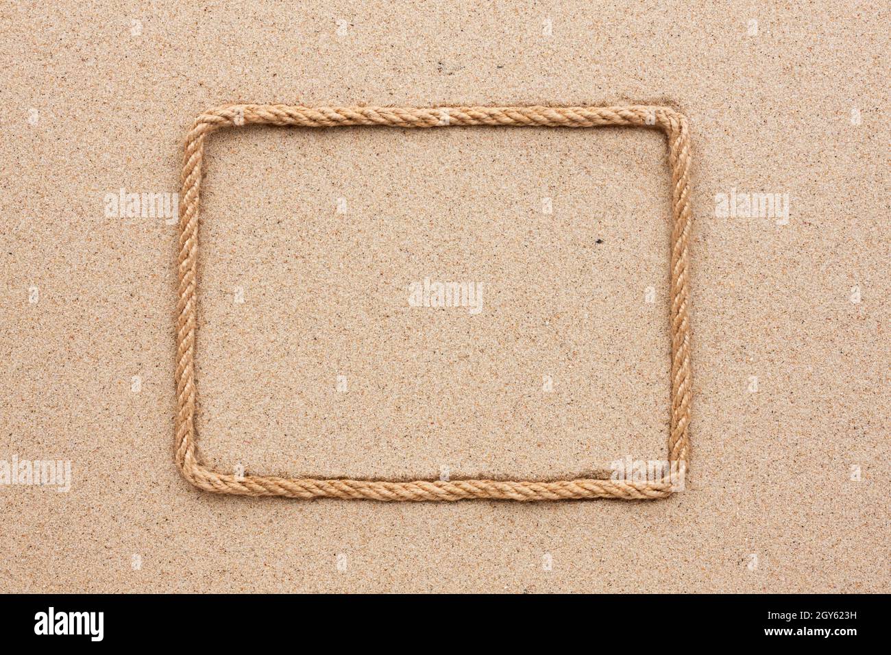 Frame made of rope lying on the sand, as background Stock Photo Alamy