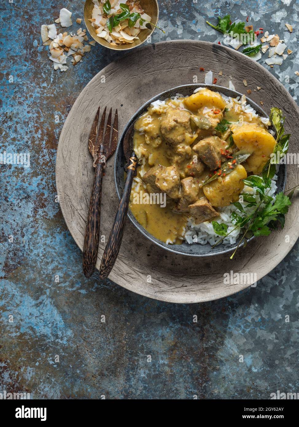 Pork Massaman Curry served with rice in a bowl with a knife and fork Stock Photo