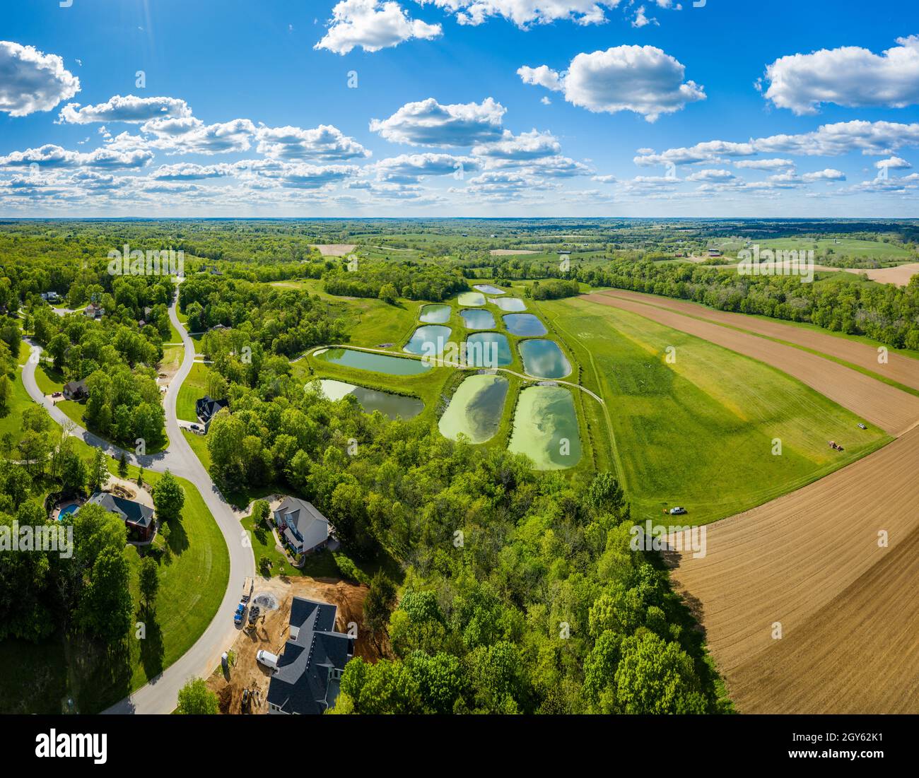 Aerial view of sewage treatment lagoons and a residential neighborhood