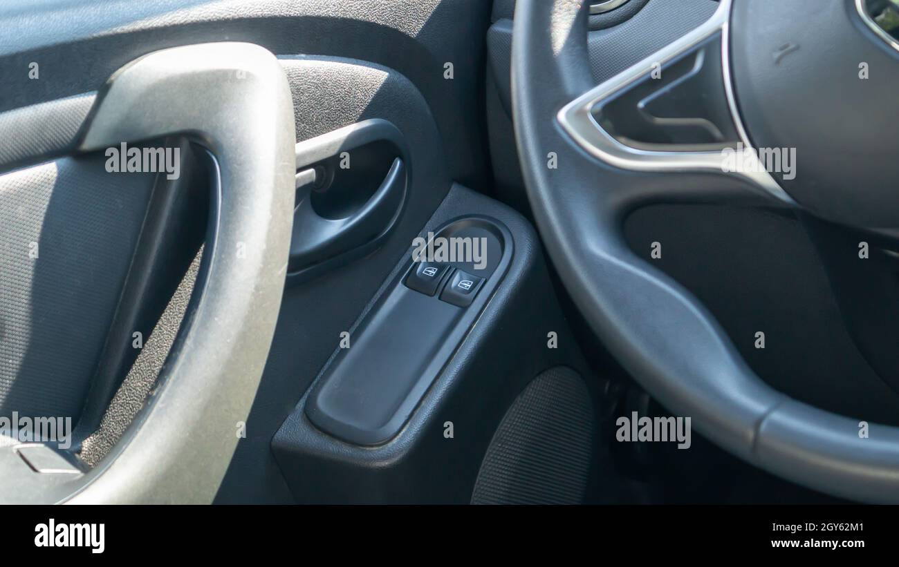 The front and rear power window buttons lower or close the car windows