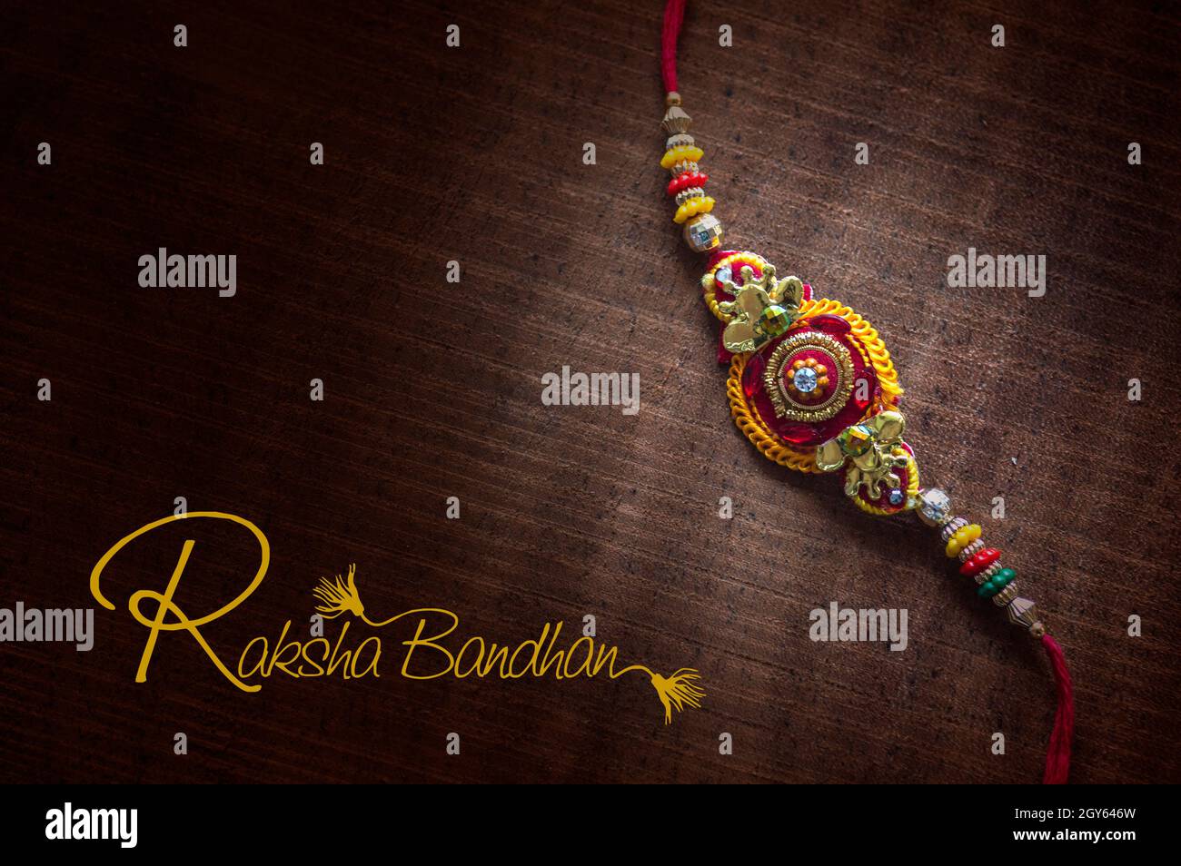 Raksha Bandhan background with an elegant Rakhi. A traditional Indian ...