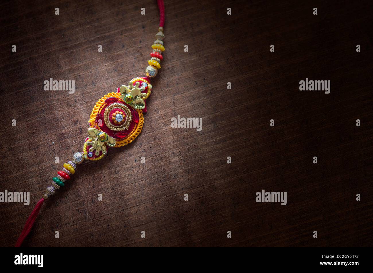 Raksha Bandhan background with an elegant Rakhi. A traditional Indian ...
