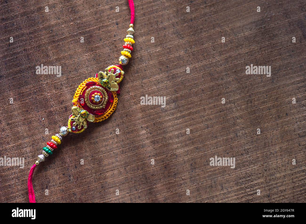 Raksha Bandhan background with an elegant Rakhi. A traditional Indian ...
