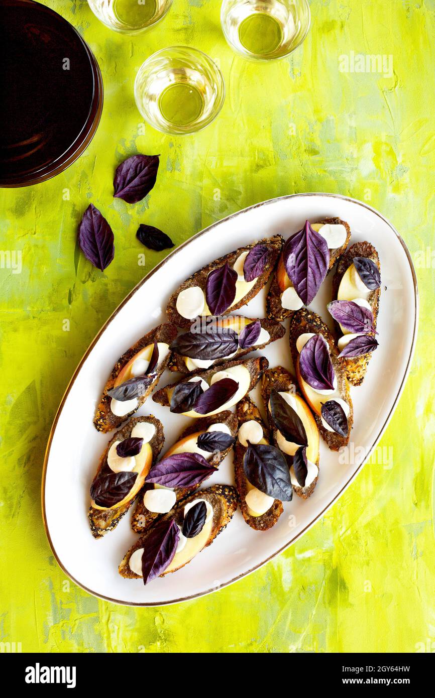 Purple Basil Pesto Crostini with Apple and Fresh Mozzarella Stock Photo