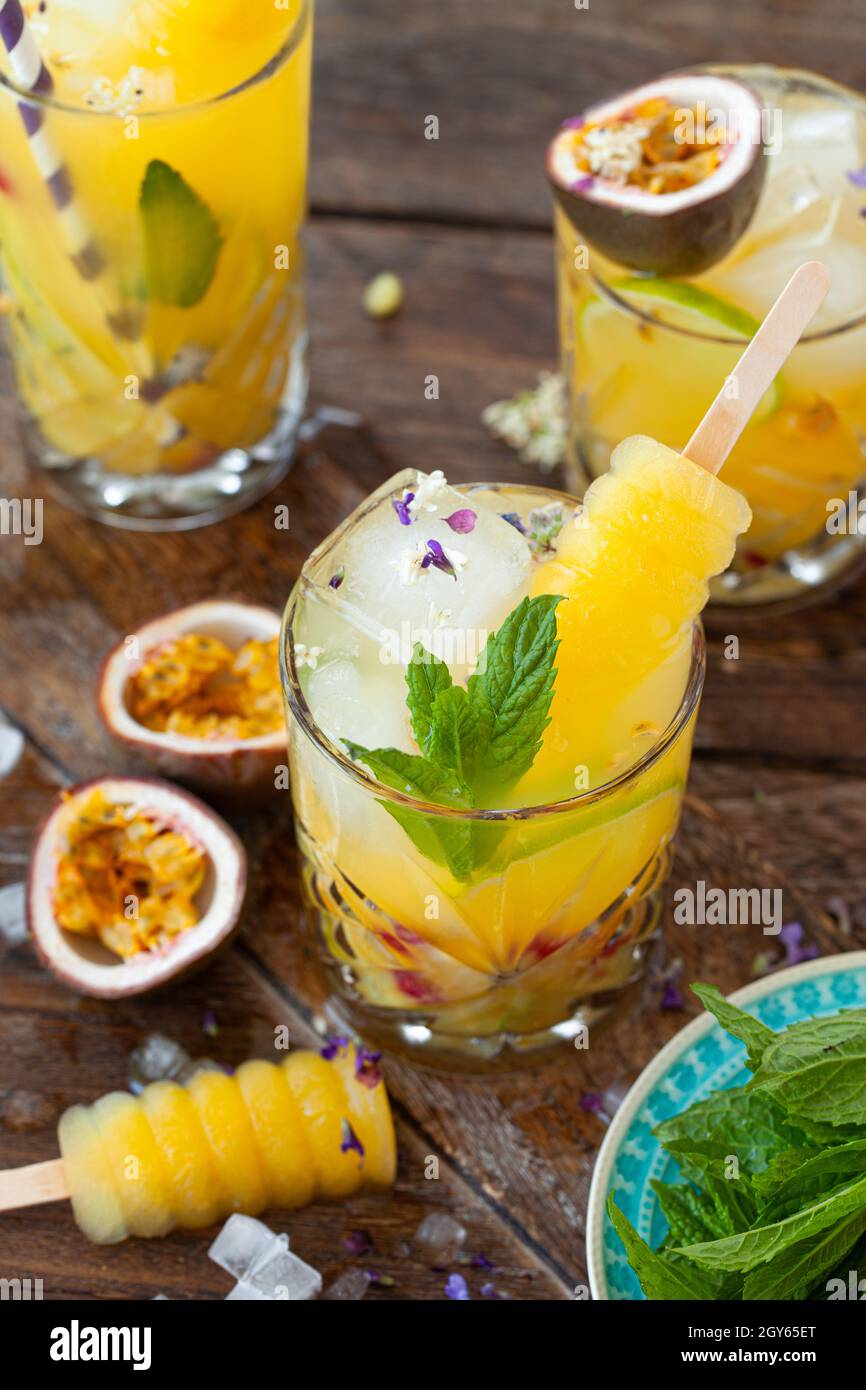 Ice cold cocktail with fresh passion fruit and mint leaves Stock Photo