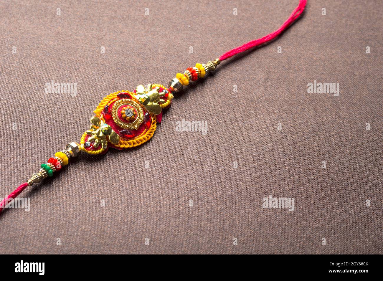 Raksha Bandhan background with an elegant Rakhi. A traditional Indian ...