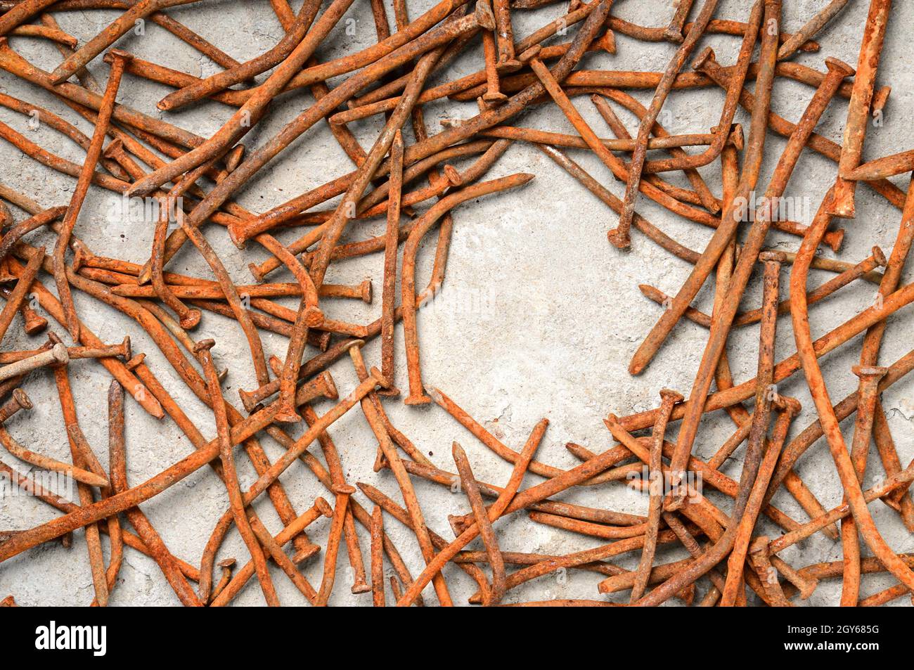 Rusty used nails on a cement metal background Stock Photo