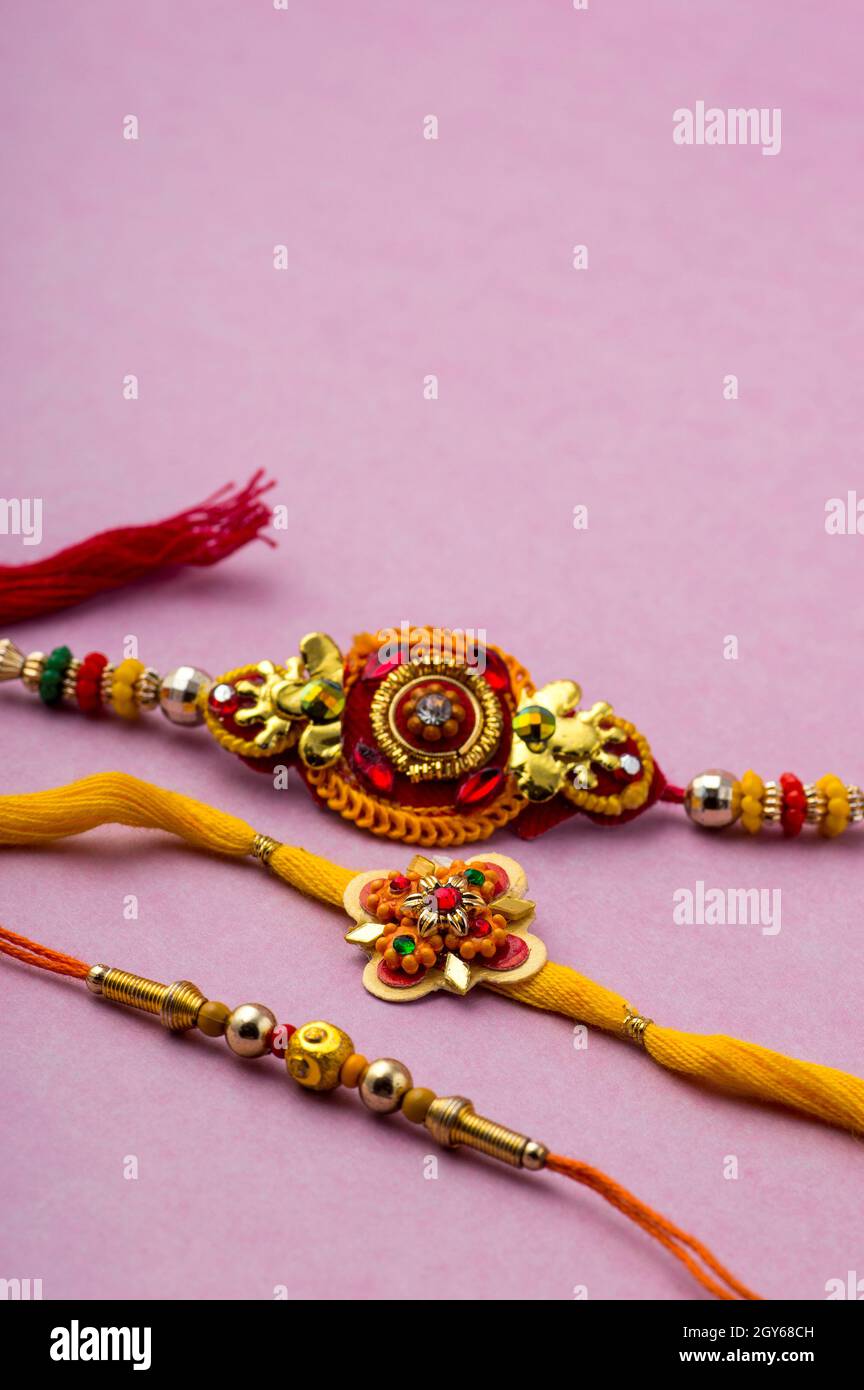 Raksha Bandhan background with an elegant Rakhi. A traditional Indian ...