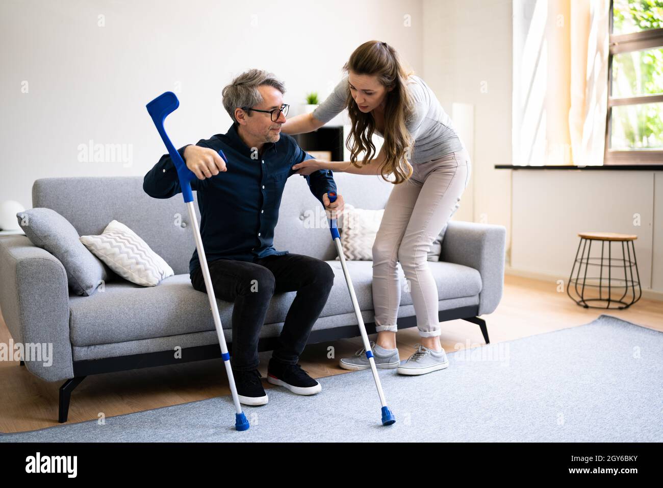 Two people together crutches hi-res stock photography and images - Alamy