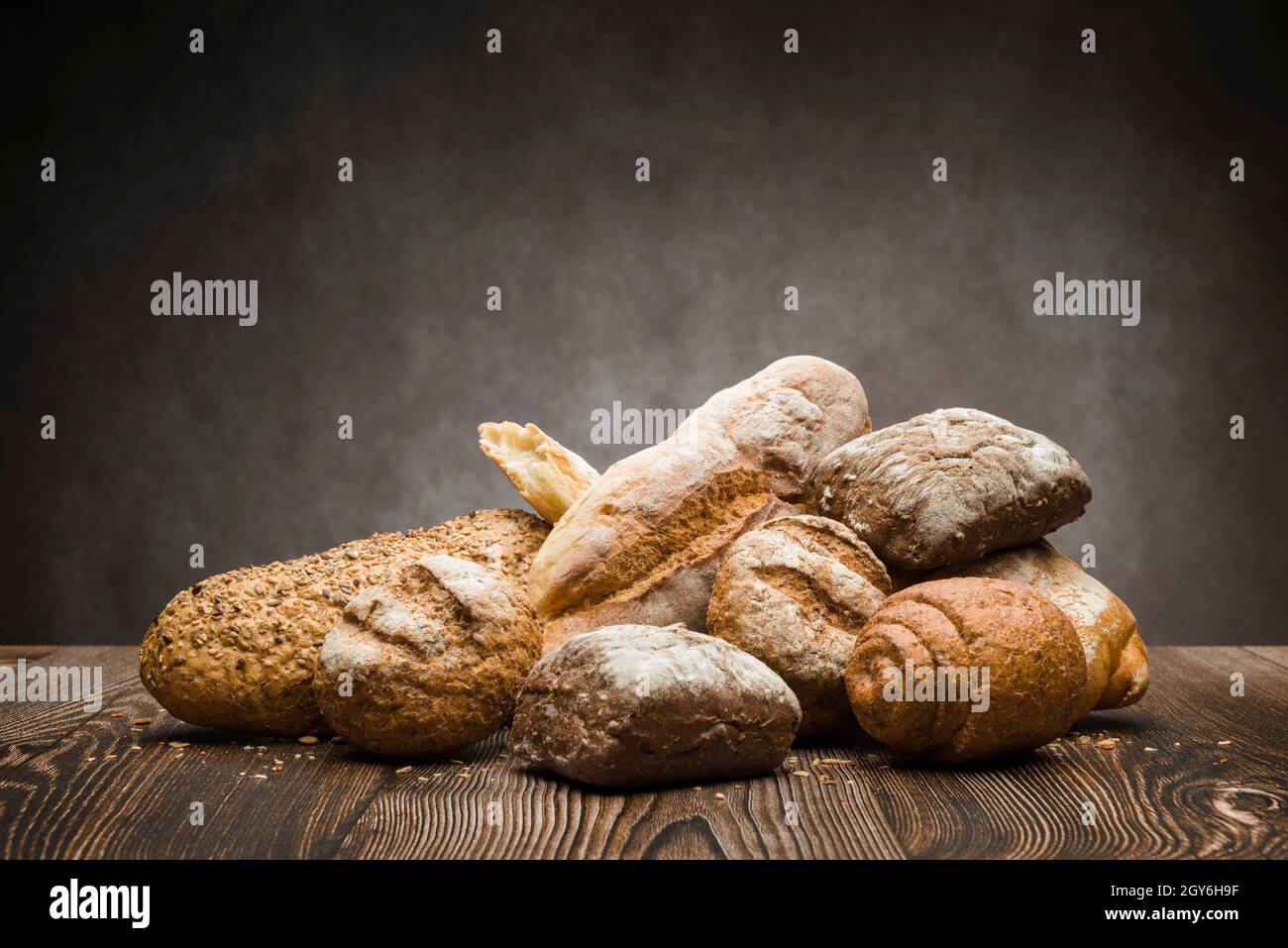assortment of baked bread on wooden table Stock Photo