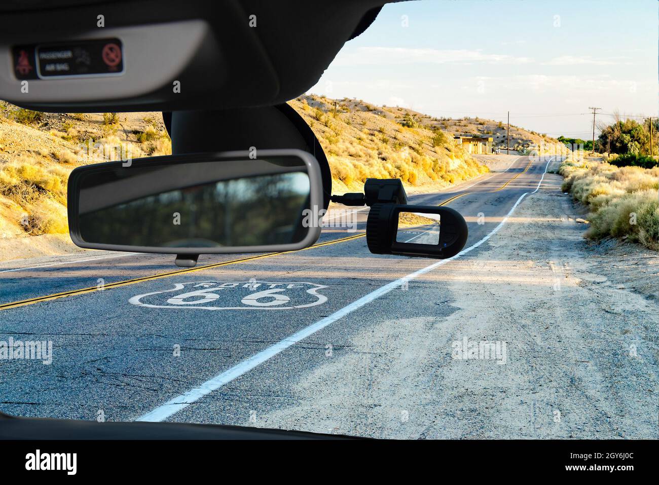 https://c8.alamy.com/comp/2GY6J0C/looking-through-a-dashcam-car-camera-installed-on-a-windshield-with-view-of-the-historic-route-66-with-pavement-sign-in-california-usa-2GY6J0C.jpg