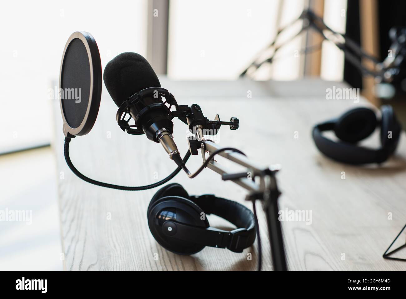 modern pop filter near adjustable scissor arm with microphone and