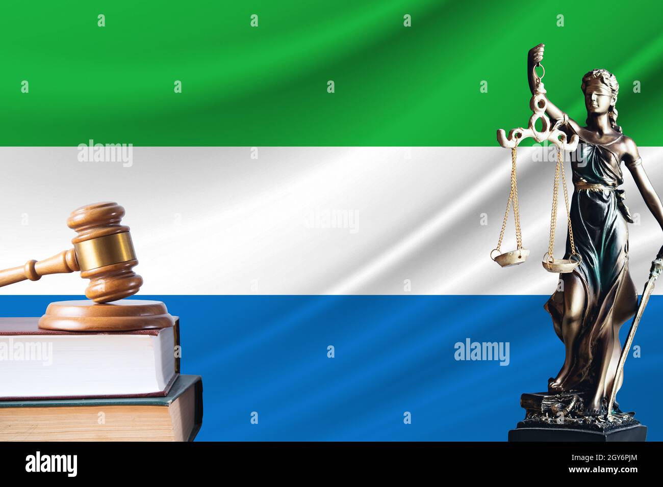 Law and justice in Sierra Leone. Statue of themis and the gavel of the judge against the background of the flag of Sierra Leone. Law and justice conce Stock Photo
