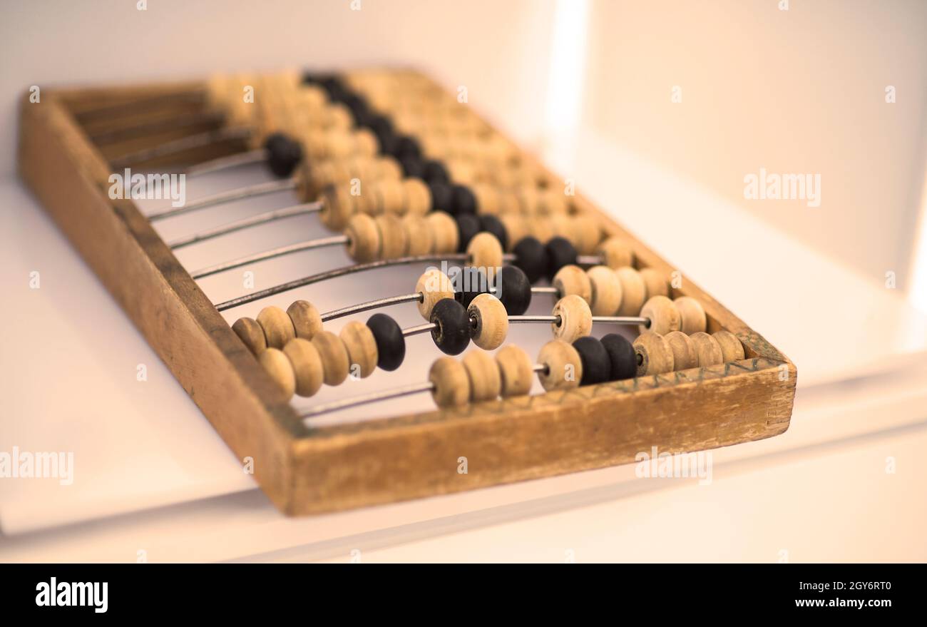 Old wooden scores. close-up abacus . Abacus on light and brown background. Concept of savings, counting. Accounting and Budget Concept. Stock Photo