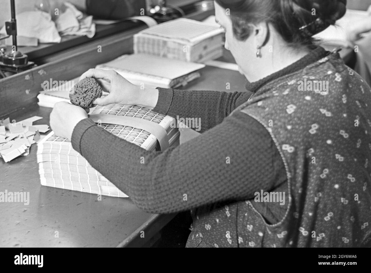 Eine Mitarbeiterin der Reichsdruckerei kommissioniert Hindenburg Dauerserie Briefmarken in Bögen in Berlin, Deutschland 1930er Jahr. A female staff member of the Reichsdruckerei printing plant in Berlin commissioning Hindenburg stamp sheets, Germany 1930s. Stock Photo
