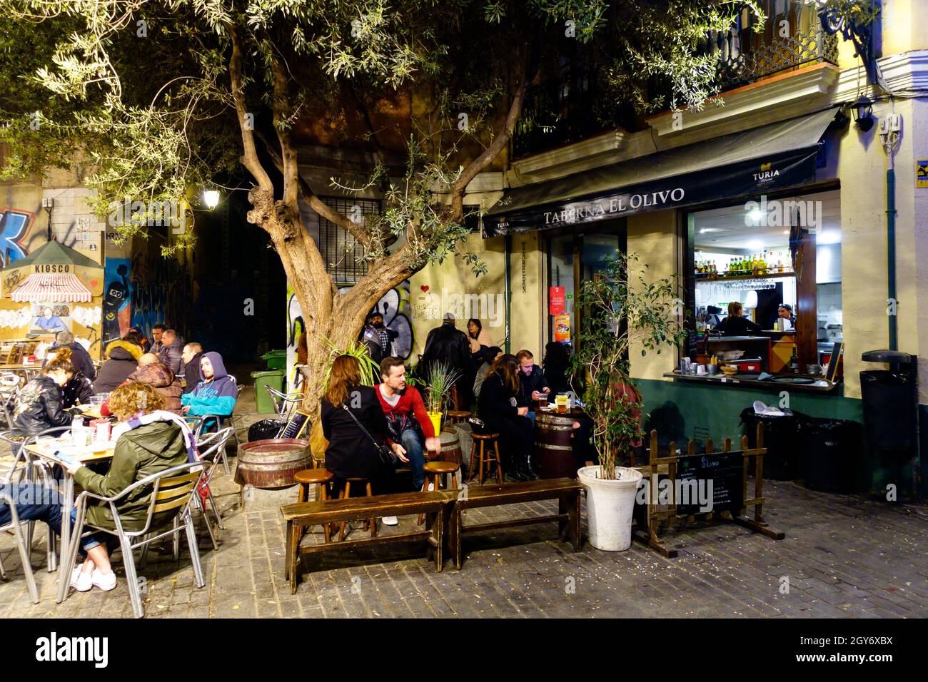 Taberna El Olivo, People sitting outside Valencia bar under olive tree  El Carmen Valencia Spain Town nightlife Stock Photo