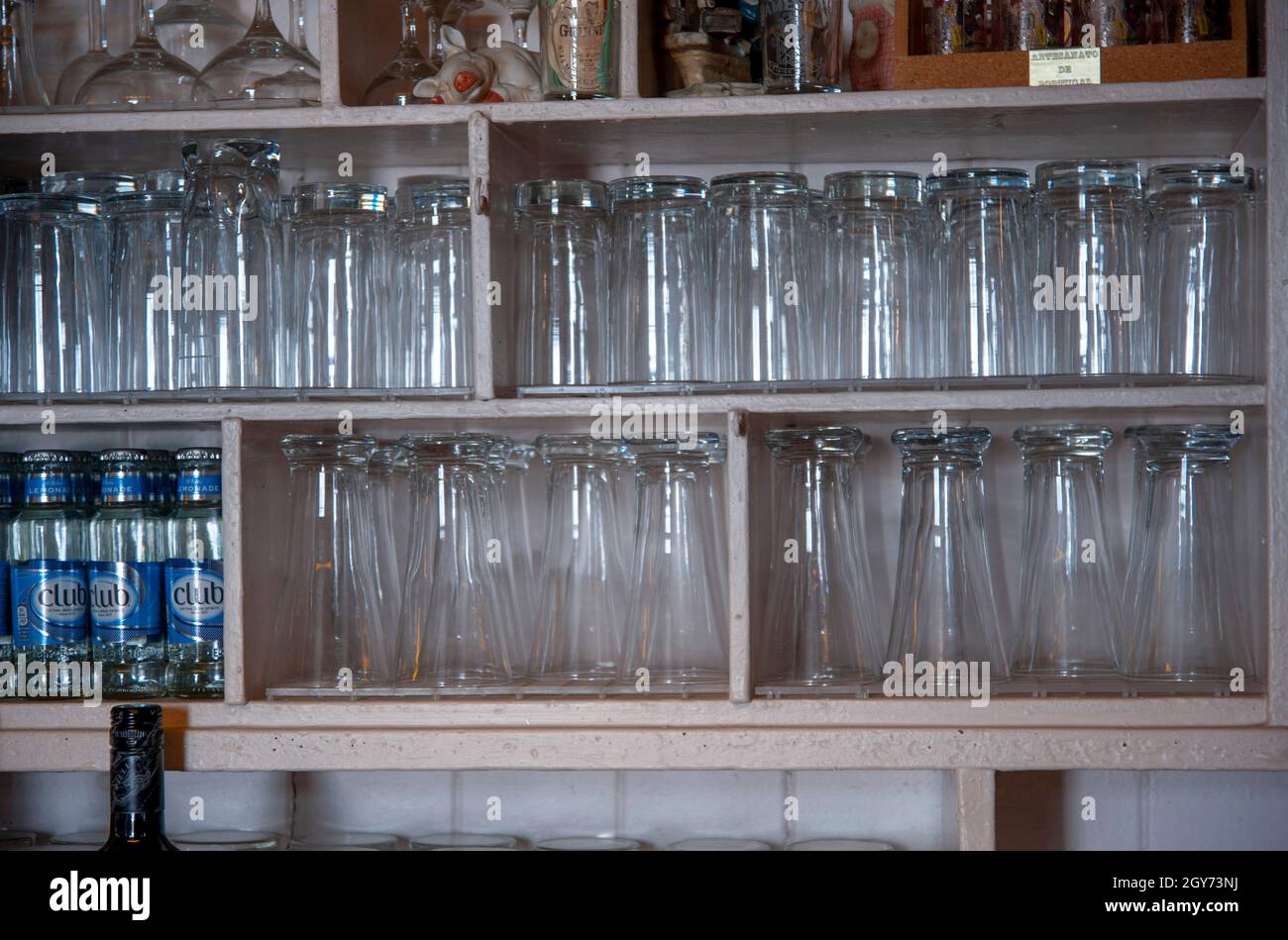 Glasses on a shelf in a rural bar in Ireland Stock Photo - Alamy