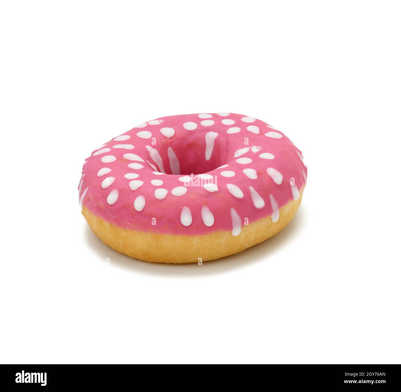 baked round donut with pink icing and white dots isolated on white background, close up Stock Photo