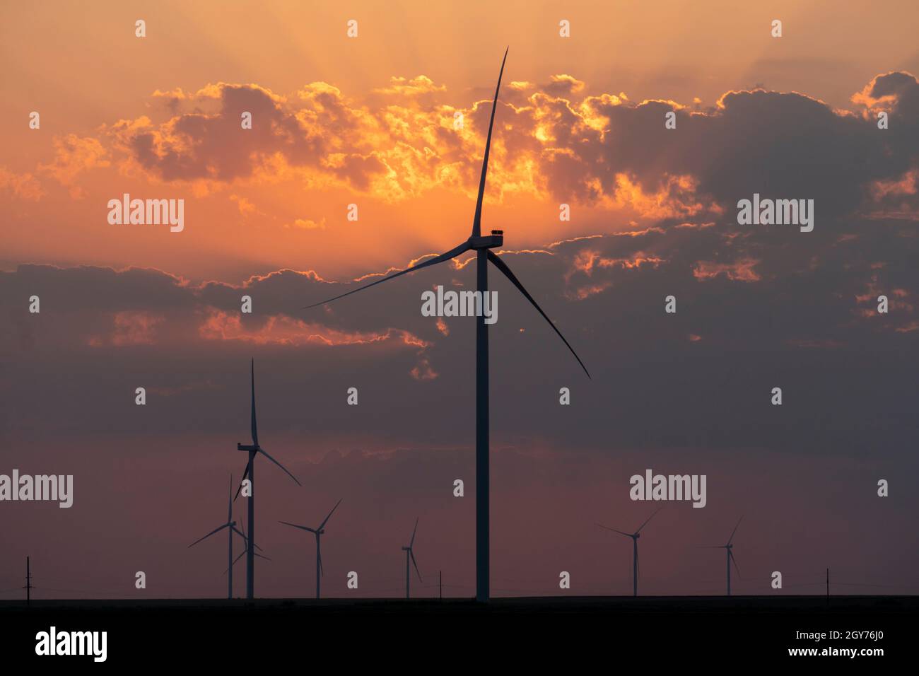 Silhouettes of wind turbines farm Behind the Lake at Sunset Stock Photo ...