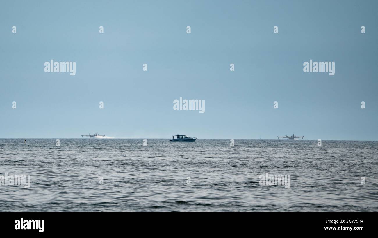 two water airplanes landing near to boat Stock Photo - Alamy
