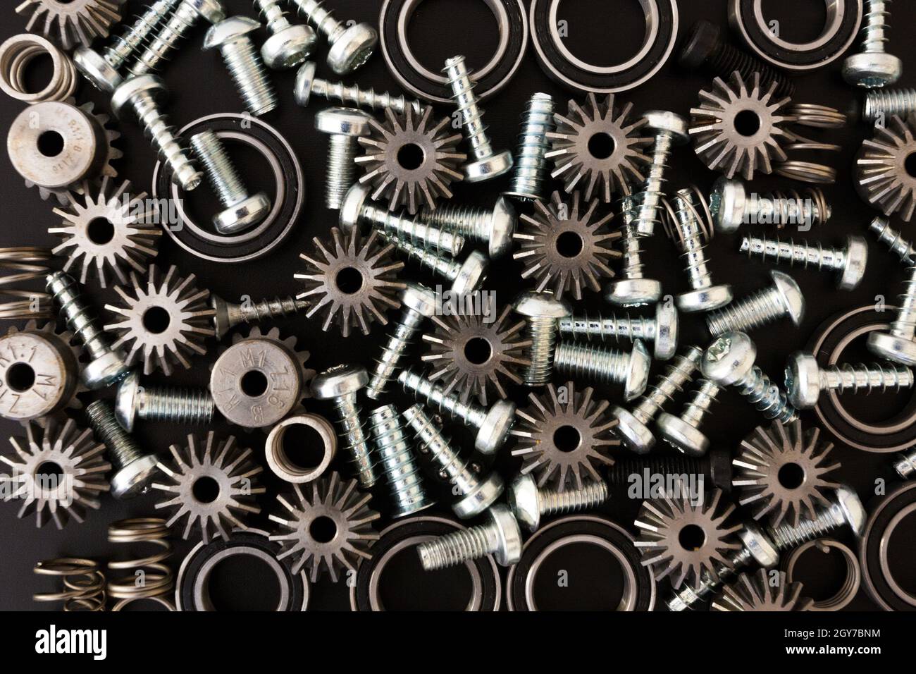Background with mechanical components, gears, springs, screws