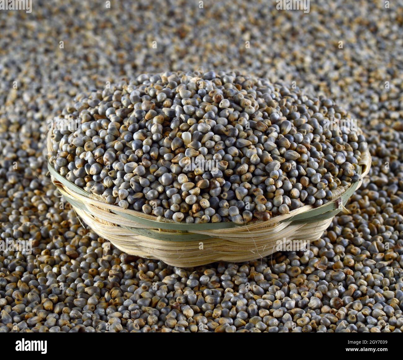 Bajra (Pearl millet) in wooden (bamboo) basket Stock Photo