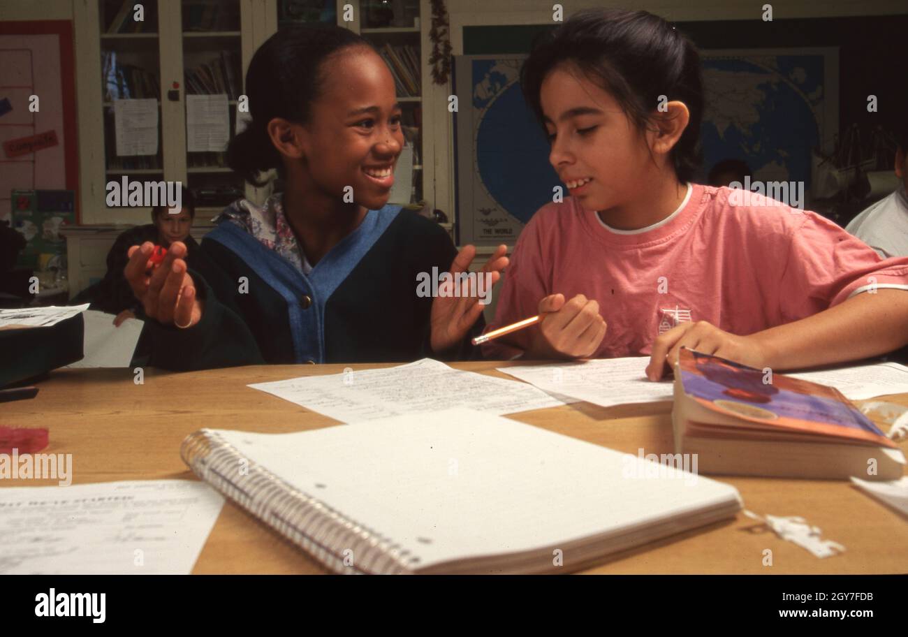 San Antonio Texas USA, October 1994: Black and Hispanic fifth grade classmates work together on math problems during class at Hawthorne Elementary School. ©Bob Daemmrich Stock Photo