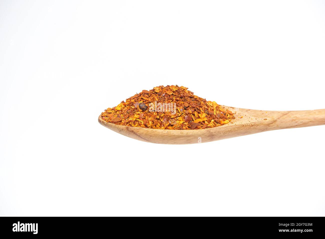 Cayenne in the wooden spoon isolated on a white background. Stock Photo