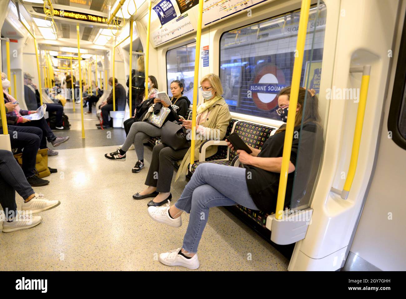 London, England, UK. People on a tube train waiting at Sloane Square station Stock Photo