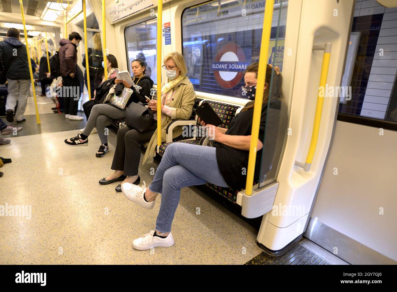 London, England, UK. People on a tube train waiting at Sloane Square station Stock Photo