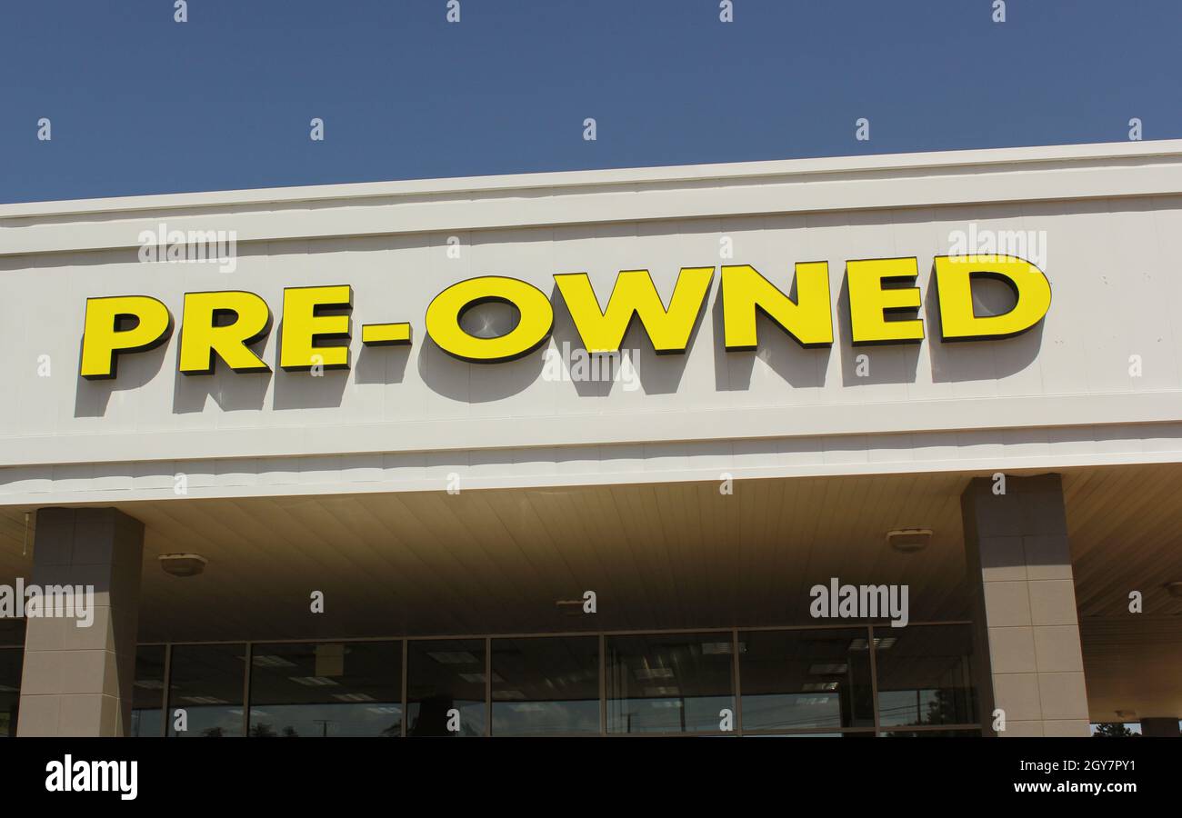 Yellow Preowned Sign on Car Dealership Stock Photo Alamy