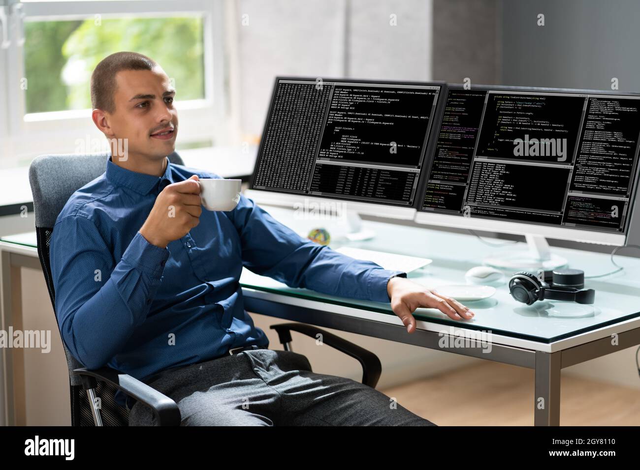 Computer Programmer Writing Program Code On Computer In Office Stock Photo