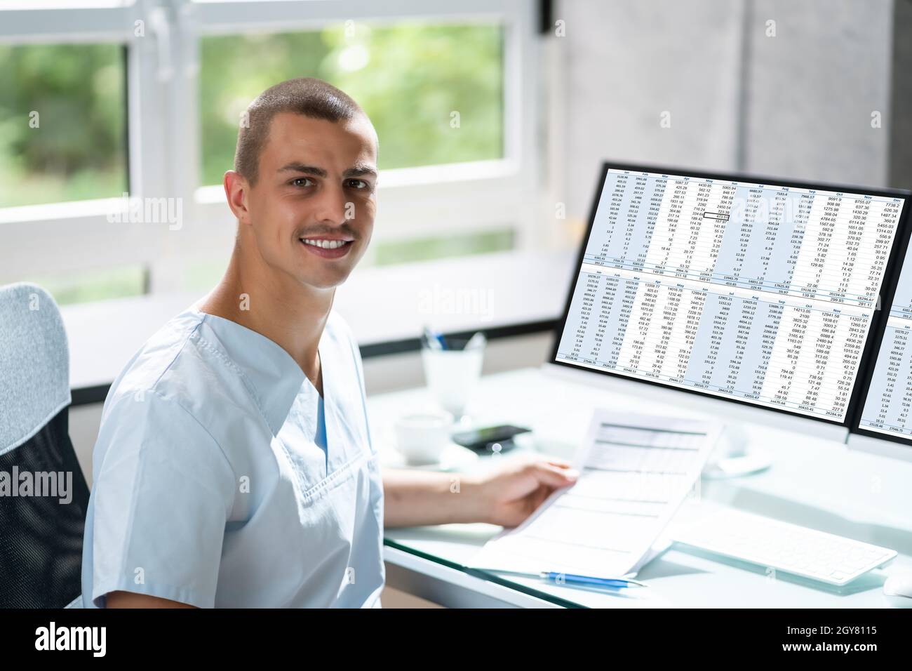 Account Manager In Office Coding Medical Bill Stock Photo