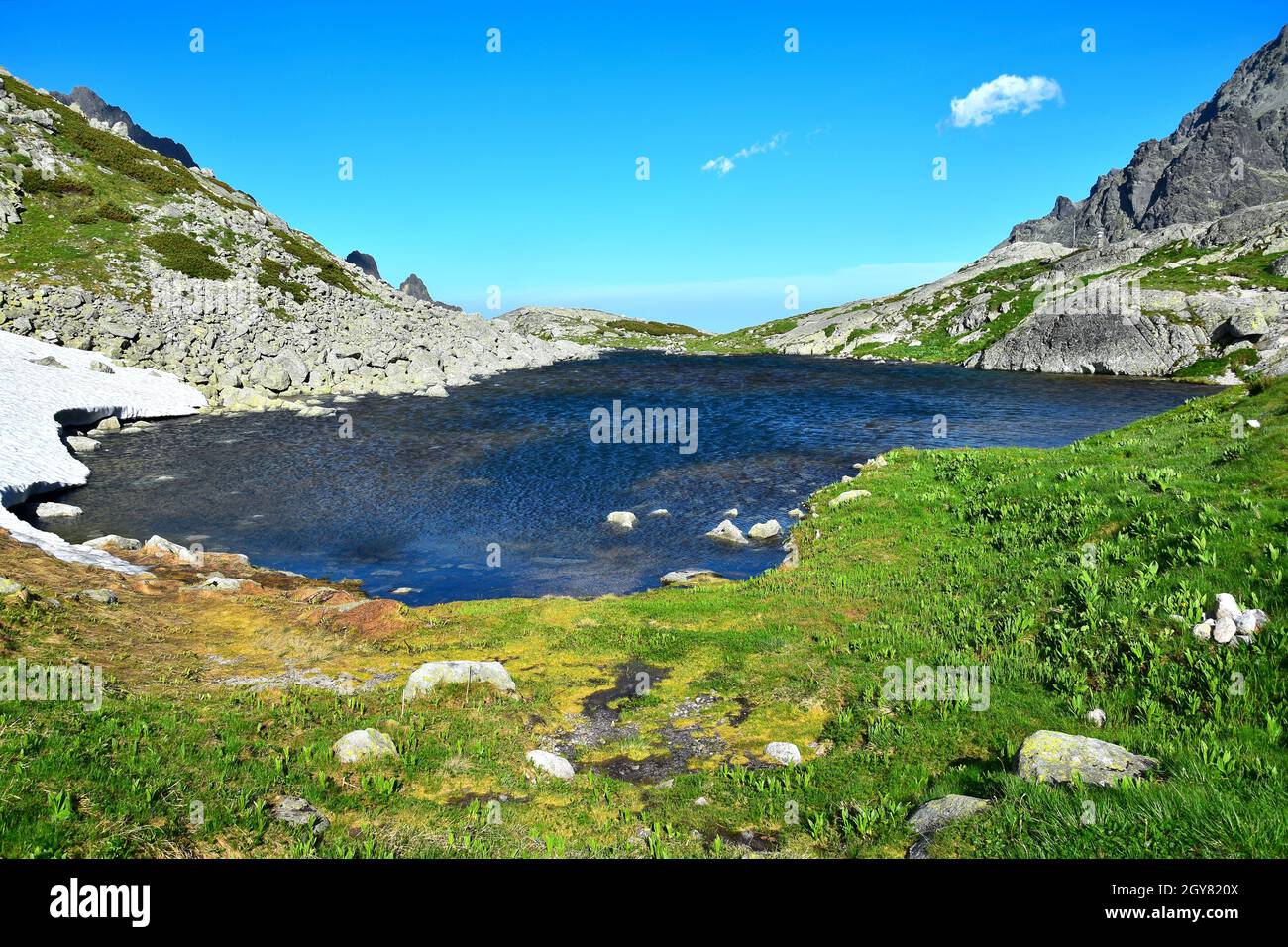 The mountain lake Starolesnianske pleso at the high end of the canyon Velka Studena Dolina in the High Tatras. Slovakia. Stock Photo