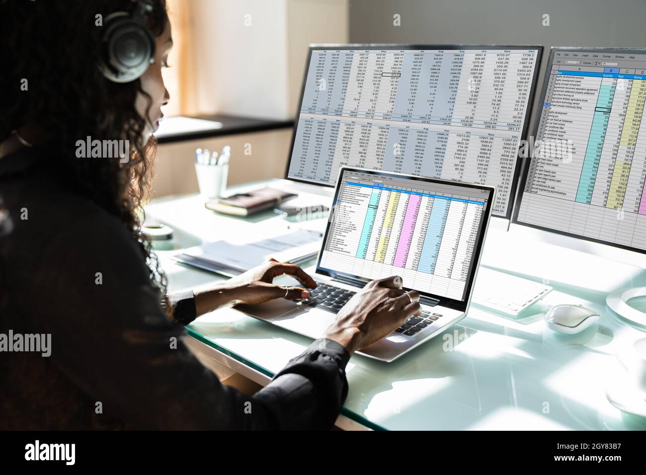 Data Analyst African Woman Using Spreadsheet On Computer Stock Photo